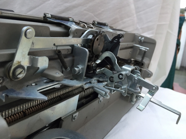 The long bar sticking out to the right is acivated by the space bar and moves the carriage forward one character. The long bar sticking out to the right is acivated by the space bar and moves the carriage forward one character.